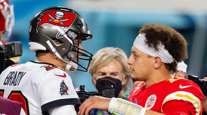 Tampa Bay Buccaneers quarterback Tom Brady (left) greets Kansas City Chiefs quarterback Patrick Mahomes following Super Bowl LV.